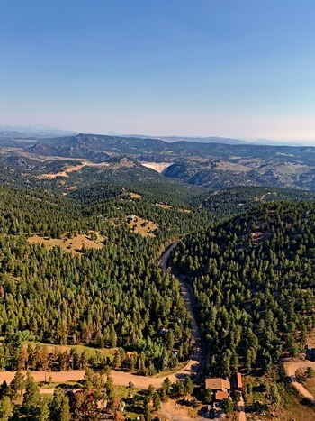 Aerial view of the forested landscape and winding road near Coal Creek Colorado United States. Aerial view of the forested landscape and winding road near Coal Creek Colorado United States.