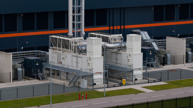 Aerial view of industrial cooling units and power infrastructure at the Agriport business park with large dark buildings and metal fencing in Middenmeer Noord Holland Netherlands. Aerial view of industrial cooling units and power infrastructure at the Agriport business park with large dark buildings and metal fencing in Middenmeer Noord Holland Netherlands.