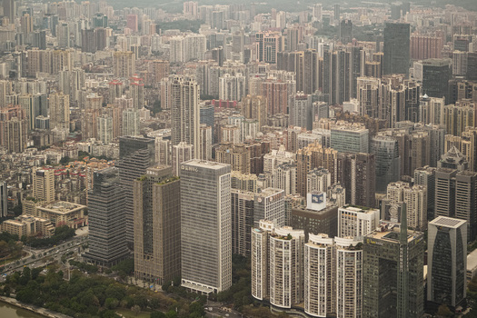 Aerial view of the dense skyline of Guangzhou featuring numerous modern skyscrapers and high rise residential buildings in Guangzhou Guangdong Province China. Aerial view of the dense skyline of Guangzhou featuring numerous modern skyscrapers and high rise residential buildings in Guangzhou Guangdong Province China.