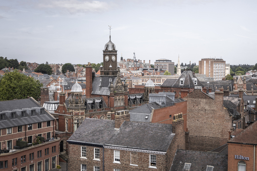 Aerial view of the historic city of York featuring the prominent clock tower red brick buildings and dense urban architecture in York England United Kingdom.