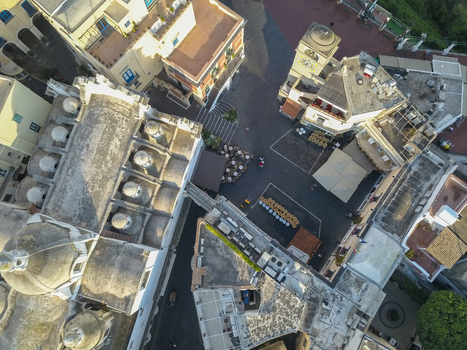 Aerial view of the historic Piazzetta and Santo Stefano church with its distinctive white domes and clock tower in Capri Campania Italy.