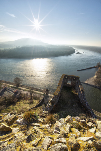 View of Devin Castle ruins overlooking the confluence of the Danube and Morava rivers under a bright sun with hazy hills and stone walls Bratislava IV Bratislava Region Slovakia. View of Devin Castle ruins overlooking the confluence of the Danube and Morava rivers under a bright sun with hazy hills and stone walls Bratislava IV Bratislava Region Slovakia.