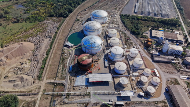 Aerial view of industrial fuel tanks and storage facilities with surrounding infrastructure and green landscape in Kovin Vojvodina Serbia. Aerial view of industrial fuel tanks and storage facilities with surrounding infrastructure and green landscape in Kovin Vojvodina Serbia.