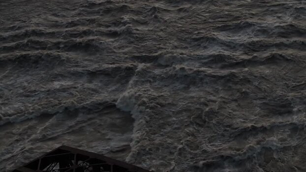 Aerial view of turbulent river water and bridge United States.