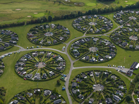 Aerial view of Haveforeningen Harekaer showing the unique circular garden communities with small houses and green hedges in Brondby Denmark. Aerial view of Haveforeningen Harekaer showing the unique circular garden communities with small houses and green hedges in Brondby Denmark.