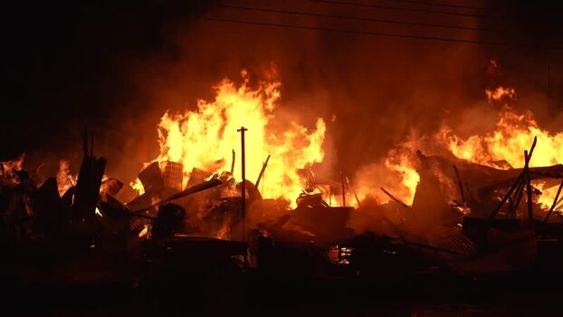 View of a large fire burning in Khagrachari Bangladesh. View of a large fire burning in Khagrachari Bangladesh.