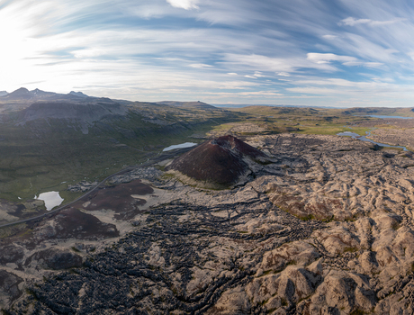 Aerial view of Ytri Raudarmelskula volcanic crater surrounded by vast lava fields rugged terrain and distant mountains in Raudhamelur Eyja og Miklaholtshreppur Iceland. Aerial view of Ytri Raudarmelskula volcanic crater surrounded by vast lava fields rugged terrain and distant mountains in Raudhamelur Eyja og Miklaholtshreppur Iceland.