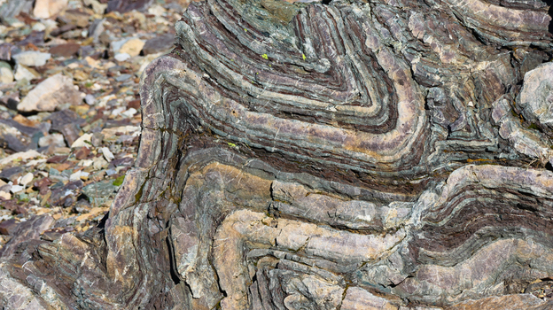 View of intricate geological rock folds with layered sedimentary strata and natural textures near Lac du Vieux Emosson in Finhaut Valais Switzerland. View of intricate geological rock folds with layered sedimentary strata and natural textures near Lac du Vieux Emosson in Finhaut Valais Switzerland.