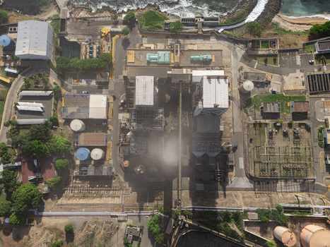 Aerial view of the industrial power plant facility with storage tanks complex infrastructure and surrounding greenery in Bajos de Haina San Cristobal Provinc Dominican Republic.