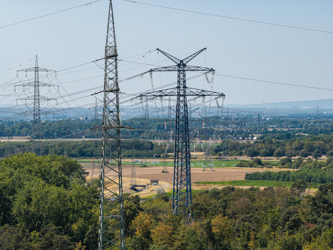 Aerial view of the Amprion Umspannwerk substation with high voltage electricity pylons and transmission lines stretching across the rural landscape of Pfungstadt Hessen Germany.