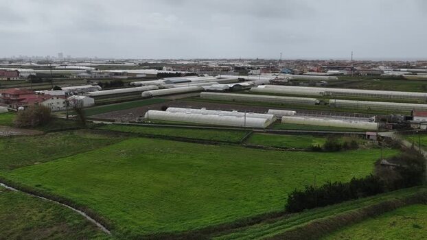 Aerial view of windmill and greenhouses Portugal.