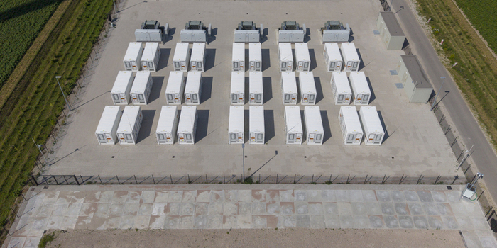 Aerial view of the Battery Energy Storage System at Wind Park featuring rows of white storage containers on a concrete pad in Dronten Flevoland Netherlands. Aerial view of the Battery Energy Storage System at Wind Park featuring rows of white storage containers on a concrete pad in Dronten Flevoland Netherlands.