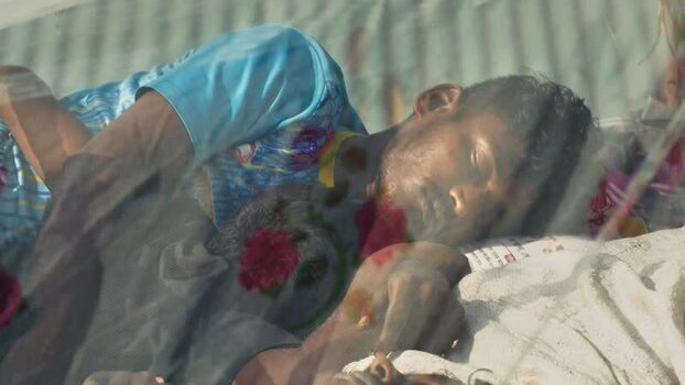 View of a man sleeping on a boat at Sadarghat Bangladesh.