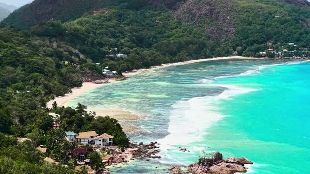 Aerial view of tropical coastline and lush hills Seychelles.