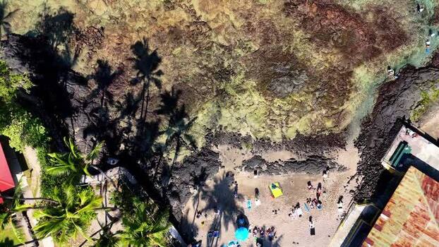 Aerial view of Kahaluu Beach Park with people on the sand United States.