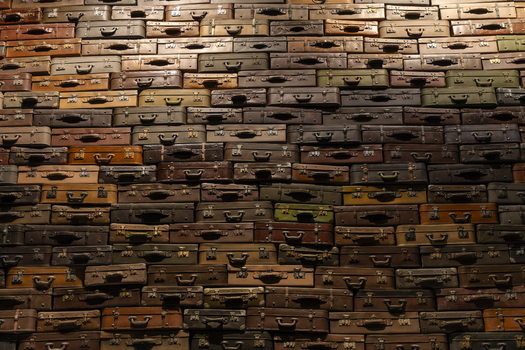 View of a wall completely covered with stacked vintage leather suitcases in various shades of brown in Gdansk Pomeranian Voivodeshi Poland. View of a wall completely covered with stacked vintage leather suitcases in various shades of brown in Gdansk Pomeranian Voivodeshi Poland.