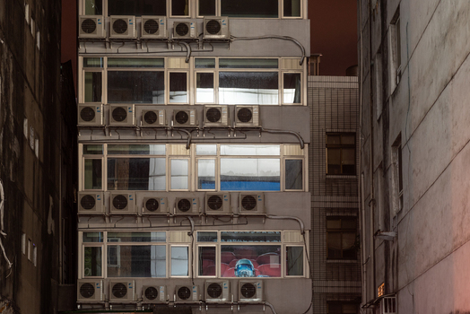 View of the facade of a building in Ximen densely covered with numerous air conditioning units and external wiring in Guangfu Village Taipei City Taiwan. View of the facade of a building in Ximen densely covered with numerous air conditioning units and external wiring in Guangfu Village Taipei City Taiwan.