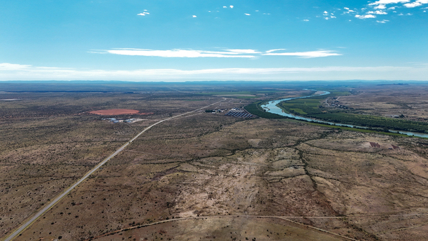 Aerial view of a winding river cutting through the arid landscape contrasting with the vast open terrain Karoo Desert Northern Cape South Africa. Aerial view of a winding river cutting through the arid landscape contrasting with the vast open terrain Karoo Desert Northern Cape South Africa.