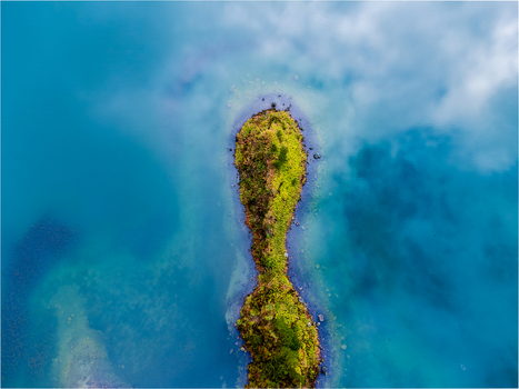 Agua de Alto Portugal 12 May 2025 Aerial view of a small green islet surrounded by turquoise volcanic lake water with cloud reflections. Agua de Alto Portugal 12 May 2025 Aerial view of a small green islet surrounded by turquoise volcanic lake water with cloud reflections.