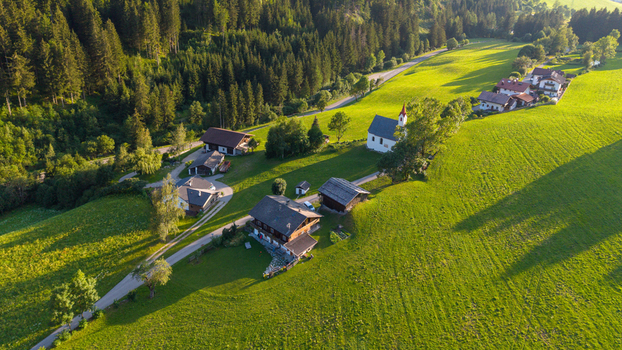 Aerial view of the village of Muhlwald with its historic church traditional wooden houses and lush green meadows nestled in the mountains of Trentino Alto Adige Italy. Aerial view of the village of Muhlwald with its historic church traditional wooden houses and lush green meadows nestled in the mountains of Trentino Alto Adige Italy.