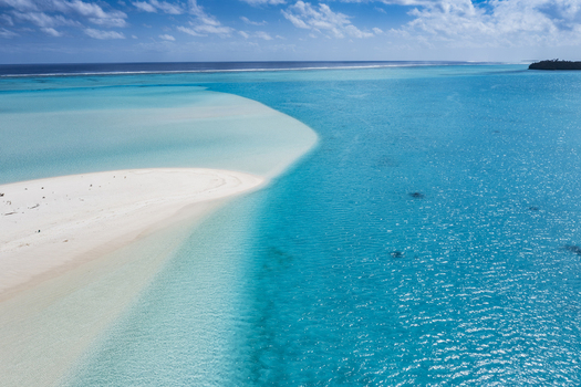 Aerial view of One Foot Island with its pristine white sandbar surrounded by the vibrant turquoise lagoon of Aitutaki in Arutanga Cook Islands. Aerial view of One Foot Island with its pristine white sandbar surrounded by the vibrant turquoise lagoon of Aitutaki in Arutanga Cook Islands.
