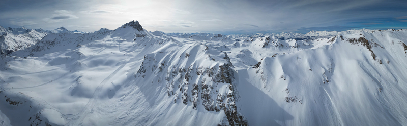 Aerial view of the majestic snow laden Becs des Bossons Peak stands tall amidst the vast undulating white landscape Anniviers Valais Switzerland.