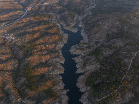Aerial view of a winding river flowing through rugged rocky hills under the warm light of the golden hour in Kirklareli Merkez Kirklareli Turkiye. Aerial view of a winding river flowing through rugged rocky hills under the warm light of the golden hour in Kirklareli Merkez Kirklareli Turkiye.
