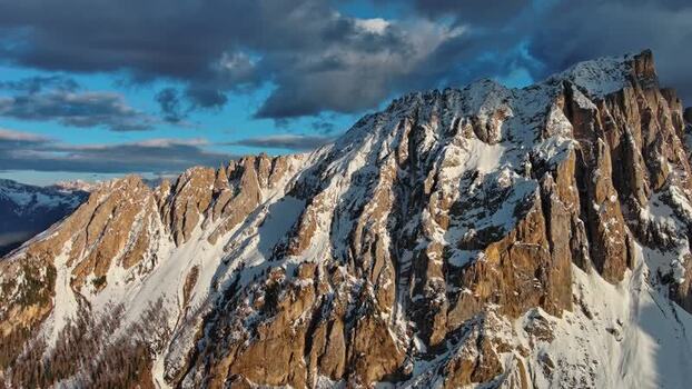 Aerial view of Dolomite Mountains with snow capped peaks Italy.