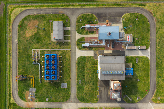 Aerial view of an industrial facility with cooling units pipes and buildings surrounded by green lawns and a perimeter road in Hrusky South Moravian Region Czechia. Aerial view of an industrial facility with cooling units pipes and buildings surrounded by green lawns and a perimeter road in Hrusky South Moravian Region Czechia.