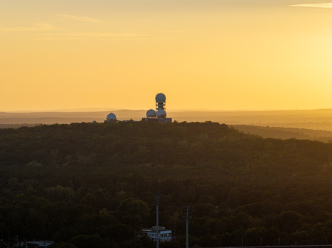 Aerial view of the former NSA listening station at Teufelsberg surrounded by the Grunewald forest during golden hour in Berlin Berlin Germany.