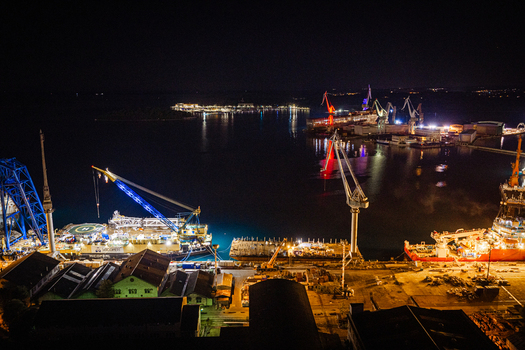 Aerial view of the illuminated Uljanik Shipyard at night with industrial cranes and harbor facilities in Pula Istria County Croatia. Aerial view of the illuminated Uljanik Shipyard at night with industrial cranes and harbor facilities in Pula Istria County Croatia.