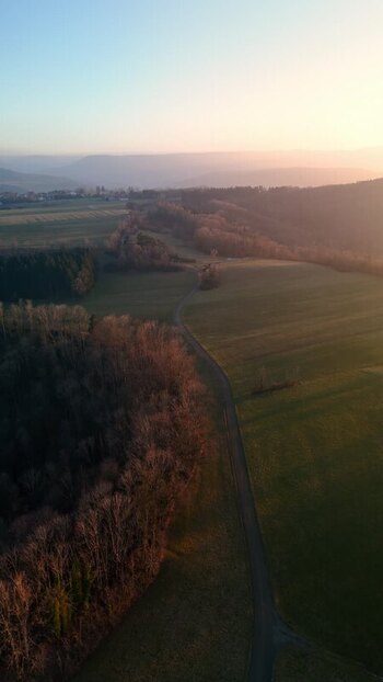 Aerial view of rolling hills and fields at sunset Germany.