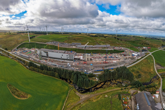 Aerial view of the Green Mountain SVG Undheim Datasenter construction site surrounded by wind turbines and rolling green hills in Undheim Rogaland Norway. Aerial view of the Green Mountain SVG Undheim Datasenter construction site surrounded by wind turbines and rolling green hills in Undheim Rogaland Norway.