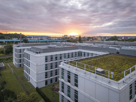 Aerial view of a modern data center complex featuring green roofs and rooftop cooling systems at sunset in Krakow Lesser Poland Voivode Poland.