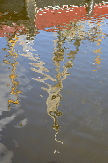 View of the colorful reflections of fishing boat masts in the water of Urk Harbour Urk Flevoland Netherlands.