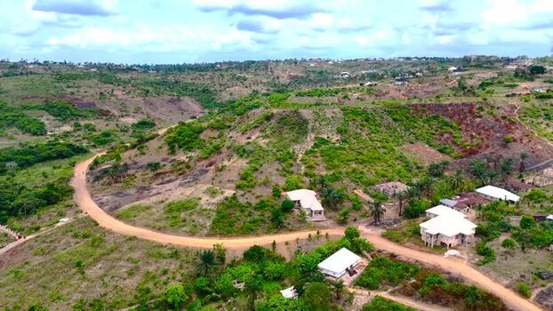 Aerial view of houses and green hills Nigeria. Aerial view of houses and green hills Nigeria.