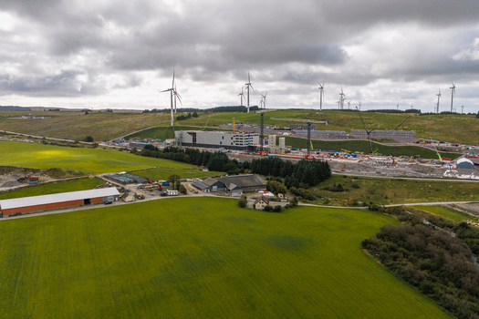 Aerial view of the Green Mountain SVG Undheim Datasenter construction site surrounded by wind turbines and lush green fields in Undheim Rogaland Norway. Aerial view of the Green Mountain SVG Undheim Datasenter construction site surrounded by wind turbines and lush green fields in Undheim Rogaland Norway.