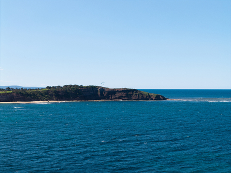 Aerial view of Northern Beaches coastline with rugged cliffs deep blue ocean waters and a clear sky Northern Beaches Council New South Wales Australia.