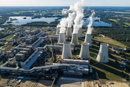 Aerial view of Janschwalde Power Station with cooling towers emitting steam plumes surrounded by industrial infrastructure and the landscape of Peitz Brandenburg Germany. Aerial view of Janschwalde Power Station with cooling towers emitting steam plumes surrounded by industrial infrastructure and the landscape of Peitz Brandenburg Germany.