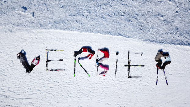 Aerial view of people and skis lying on the snow to spell the word Verbier at the ski resort in Val de Bagnes Valais Switzerland.