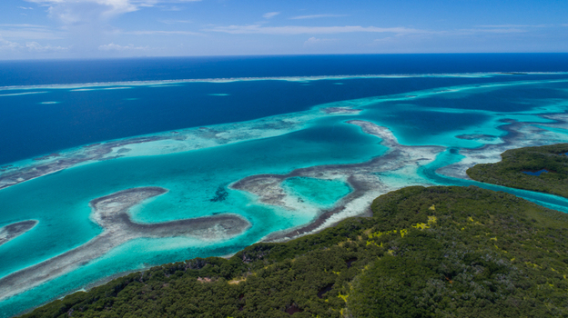 Aerial view of Los Roques archipelago featuring vibrant turquoise waters coral reefs and lush green islands under a clear blue sky in Los Roques Dependencias Federales Venezuela. Aerial view of Los Roques archipelago featuring vibrant turquoise waters coral reefs and lush green islands under a clear blue sky in Los Roques Dependencias Federales Venezuela.