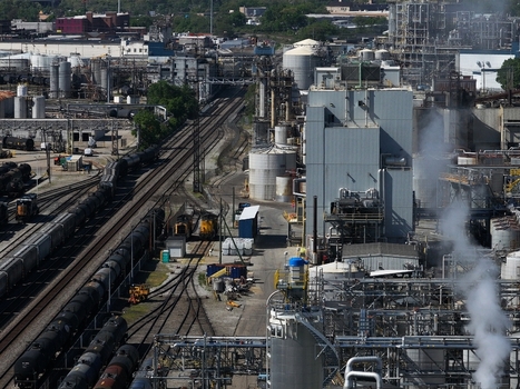 Aerial view of a large industrial complex featuring storage tanks complex piping and railway tracks with freight cars Cincinnati OH United States. Aerial view of a large industrial complex featuring storage tanks complex piping and railway tracks with freight cars Cincinnati OH United States.