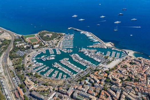 Aerial view of Port Vauban featuring luxury yachts and sailboats in the marina surrounded by historic buildings and fortifications in Antibes Provence Alpes Cote d Azur France. Aerial view of Port Vauban featuring luxury yachts and sailboats in the marina surrounded by historic buildings and fortifications in Antibes Provence Alpes Cote d Azur France.