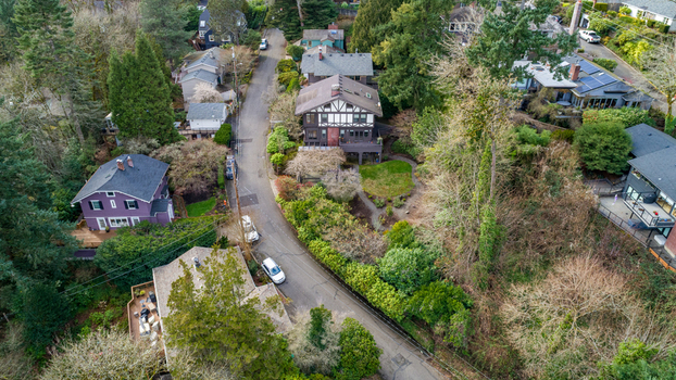 Aerial view of the Northwest Imperial Terrace neighborhood featuring residential houses nestled among lush green trees and winding streets Portland Oregon United States. Aerial view of the Northwest Imperial Terrace neighborhood featuring residential houses nestled among lush green trees and winding streets Portland Oregon United States.