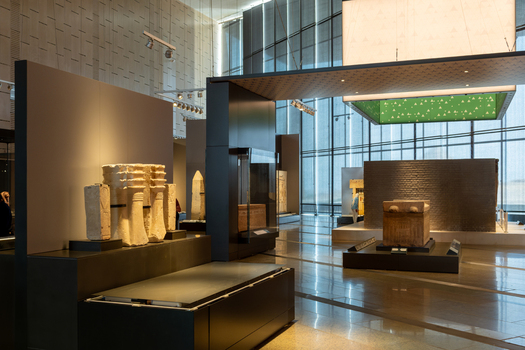 Giza Egypt 16 May 2026 View of Grand Egyptian Museum interior featuring ancient stone artifacts sarcophagi and modern exhibition displays under soft indoor lighting.