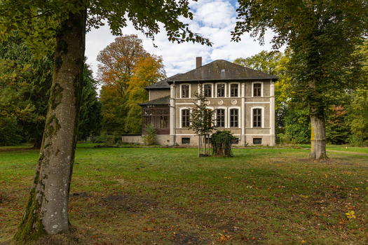 View of a historic villa surrounded by trees and autumn foliage in a park like setting in Tiste Niedersachsen Germany. View of a historic villa surrounded by trees and autumn foliage in a park like setting in Tiste Niedersachsen Germany.