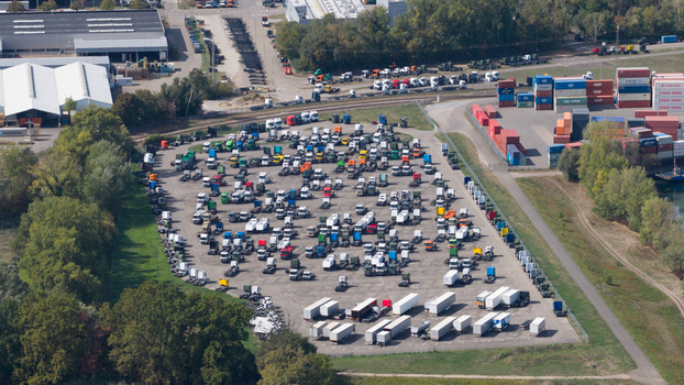 Worth am Rhein Germany 19 September 2026 Aerial view of the Mercedes Benz Werk Worth truck plant featuring a parking area filled with trucks and trailers near industrial warehouses.