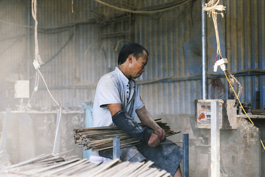 Ung Hoa Vietnam 23 July 2023 View of a man working on incense in a traditional workshop Quang Phu Cau Vietnam.