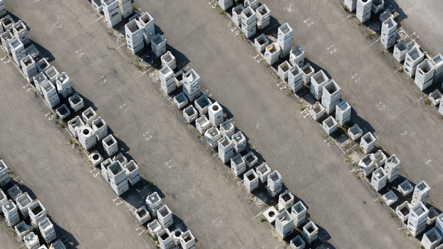 Aerial view of rows of precast concrete blocks and industrial components stored in an asphalt yard with numbered sections in Oosterhout North Brabant Netherlands. Aerial view of rows of precast concrete blocks and industrial components stored in an asphalt yard with numbered sections in Oosterhout North Brabant Netherlands.