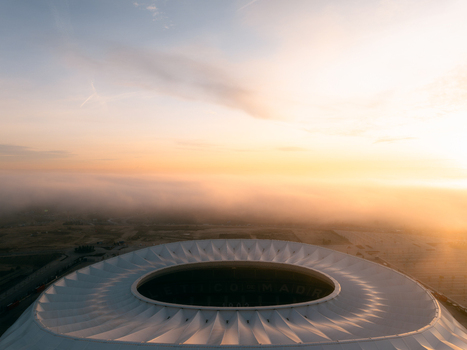 Aerial view of Riyadh Air Metropolitano Stadium surrounded by morning fog at sunrise in Madrid Comunidad de Madrid Spain.